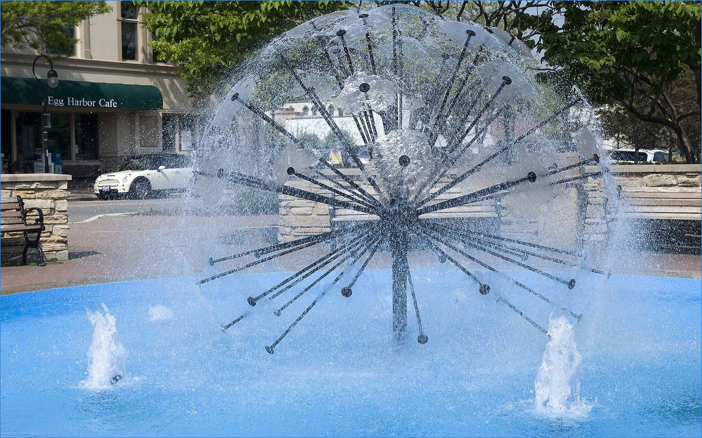 The Dandelion Fountain spraying on the Naperville Riverwalk